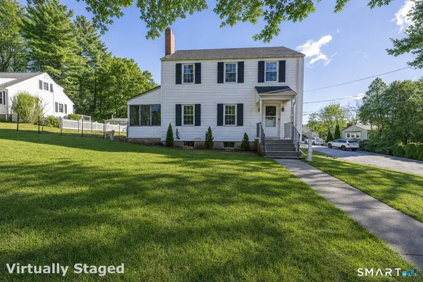 a front view of a house with a garden