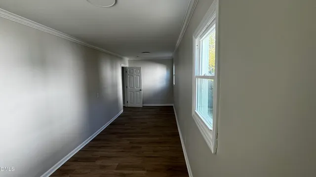 a kitchen with granite countertop wooden floors and white stainless steel appliances