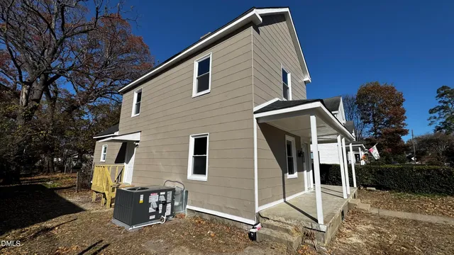 a backyard of a house with table and chairs