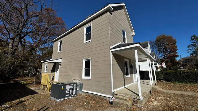 a backyard of a house with table and chairs