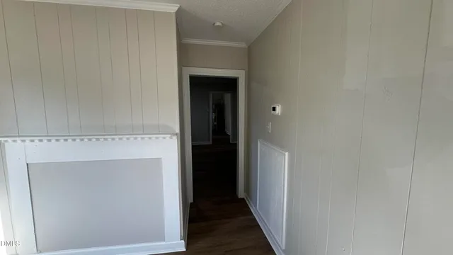 a view of an empty room and wooden floor