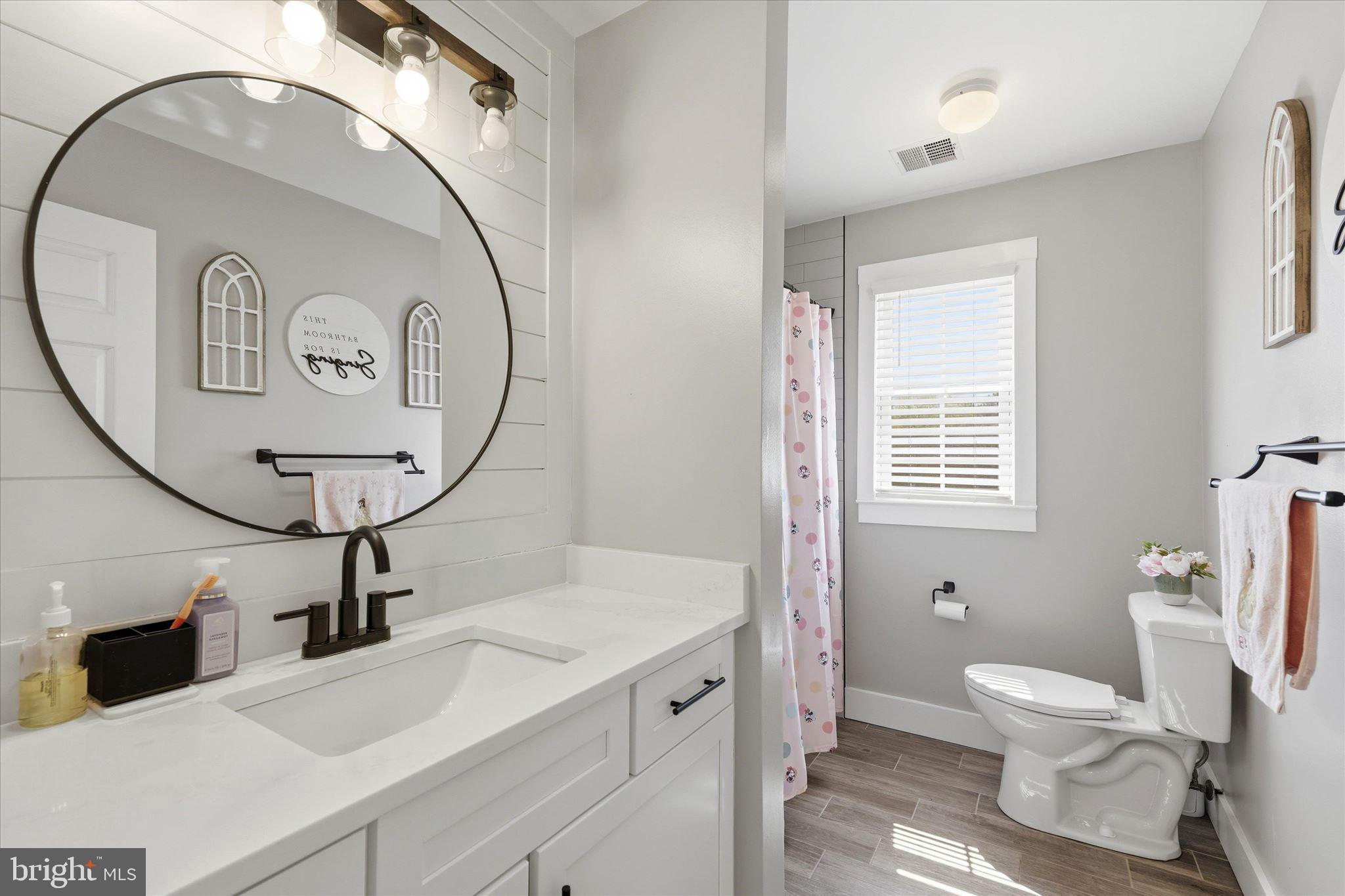 176 Warren Grove Road Barnegat, NJ 08005 - Photo 37 of 71 a spacious bathroom with a toilet a sink and a mirror