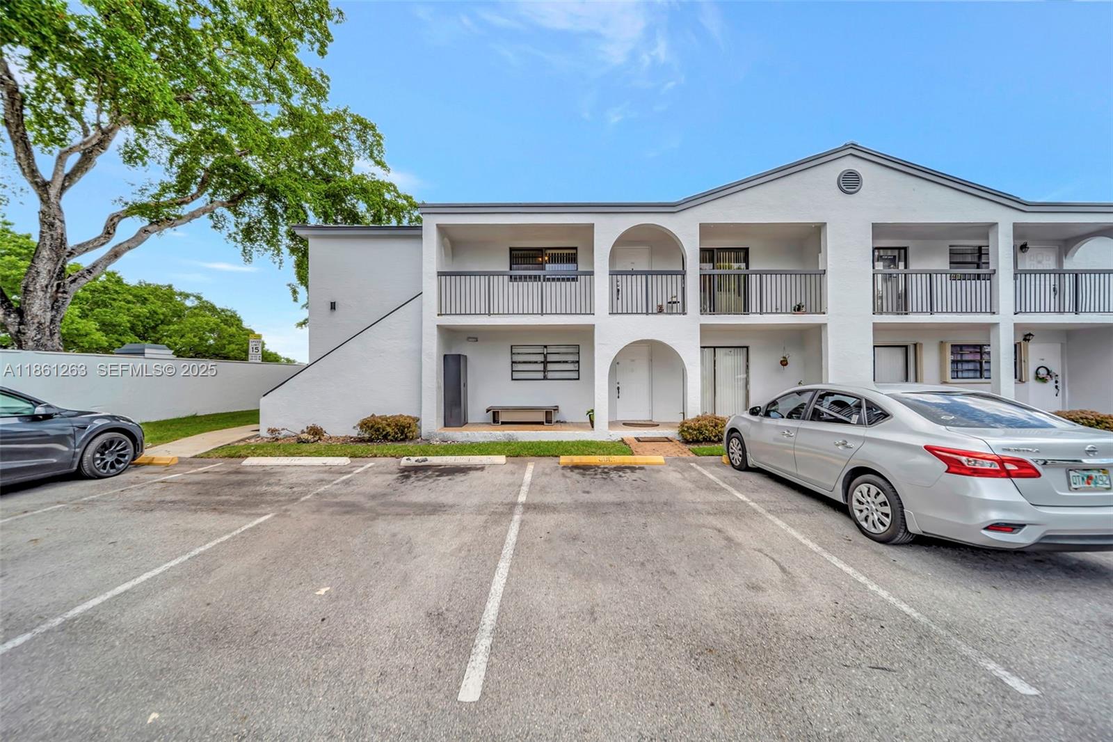 18224 Mediterranean Boulevard, Unit 61706 Hialeah, FL 33015 - Photo 22 of 50 a view of a cars park in front of a house