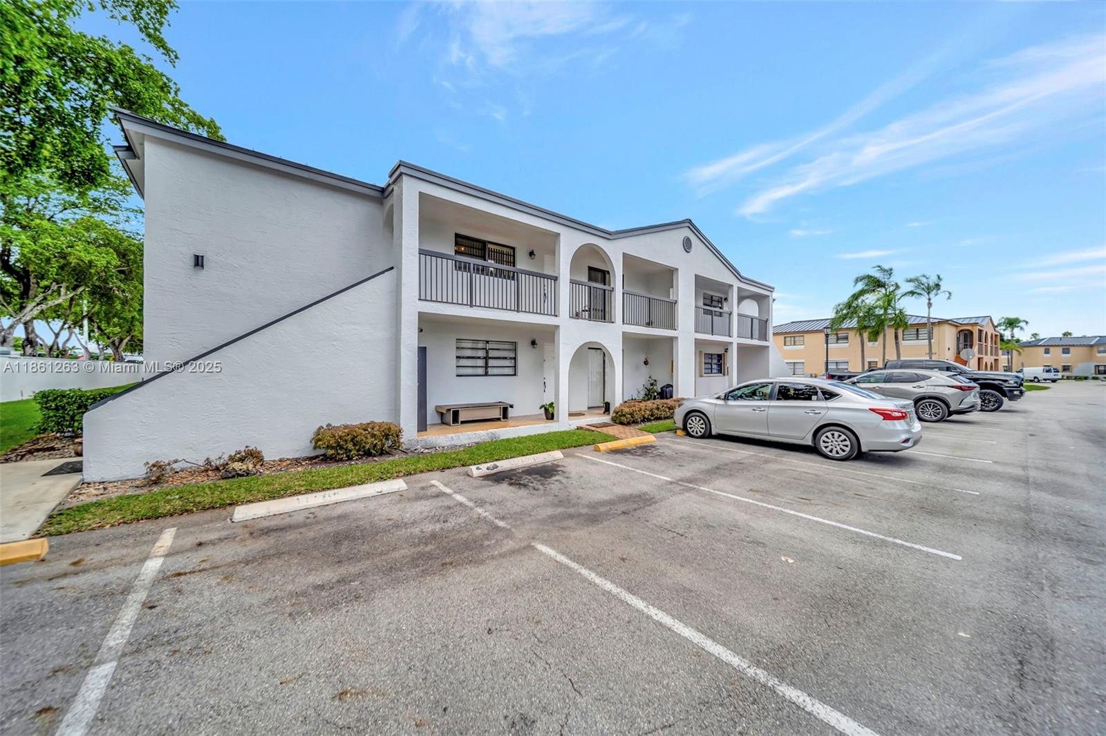 18224 Mediterranean Boulevard, Unit 61706 Hialeah, FL 33015 - Photo 23 of 50 a view of a cars park in front of house