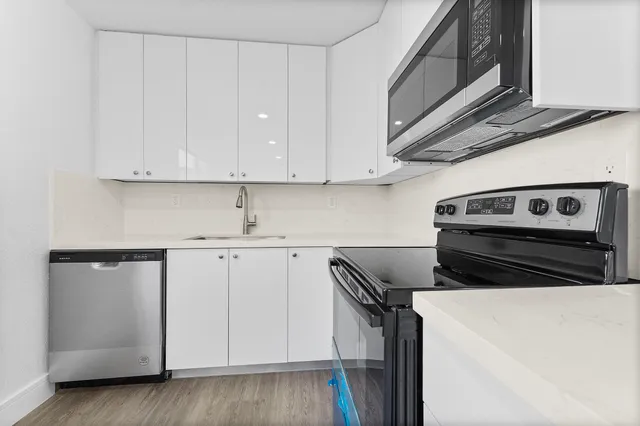 a kitchen with a sink and cabinets