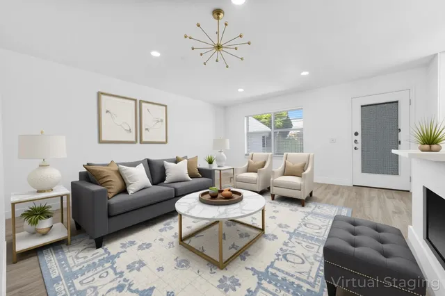 a living room with furniture a rug and a chandelier