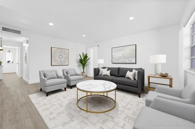 a living room with furniture a rug and a table