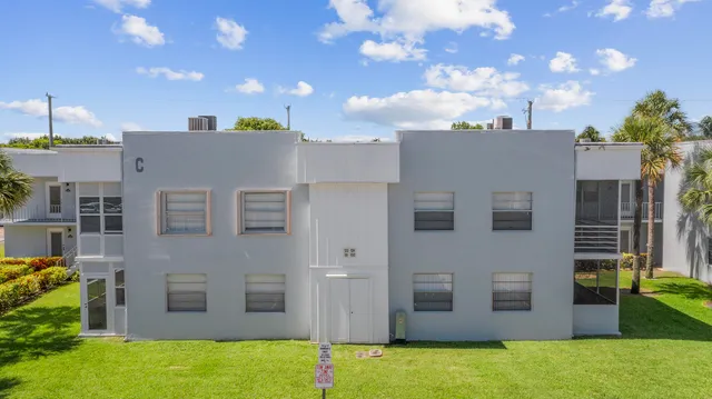 a view of a house with a yard and a fountain