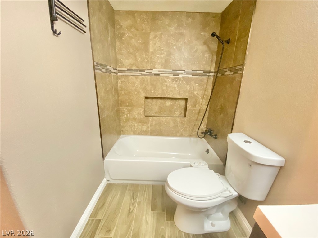 2000 Turquoise Ridge Street, Unit 204 Las Vegas, NV 89117 - Photo 24 of 29 A well-appointed bathroom with durable wood-look tile flooring and stylish tiled shower surround.