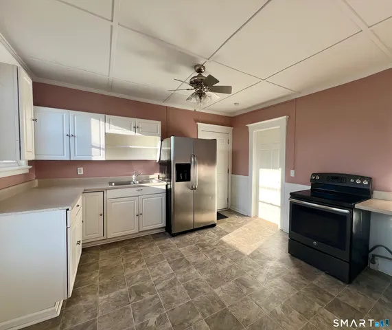 a bathroom with a granite countertop sink a toilet and a mirror