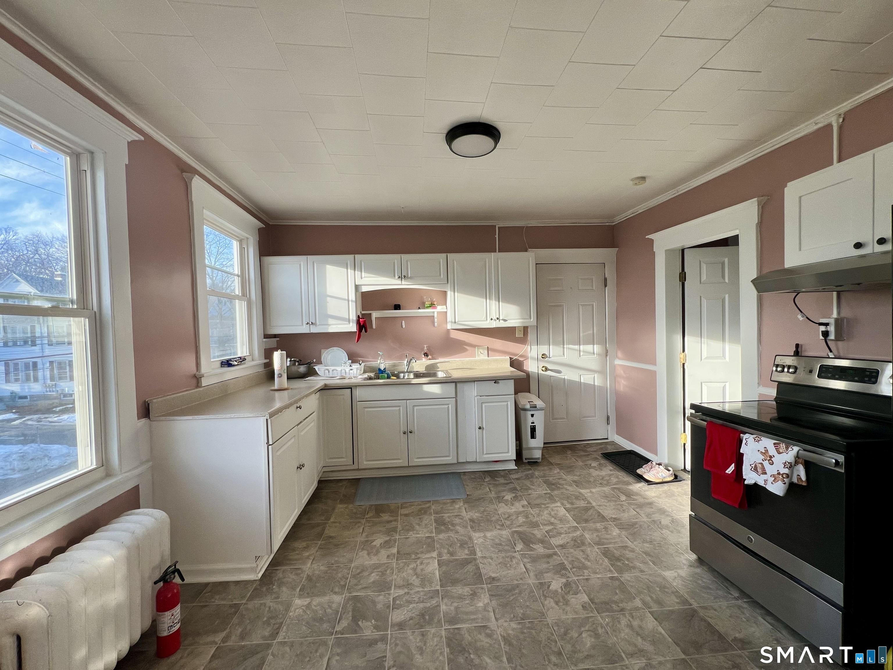 154 High Street Torrington, CT 06790 - Photo 19 of 36 a kitchen with a sink stove and cabinets