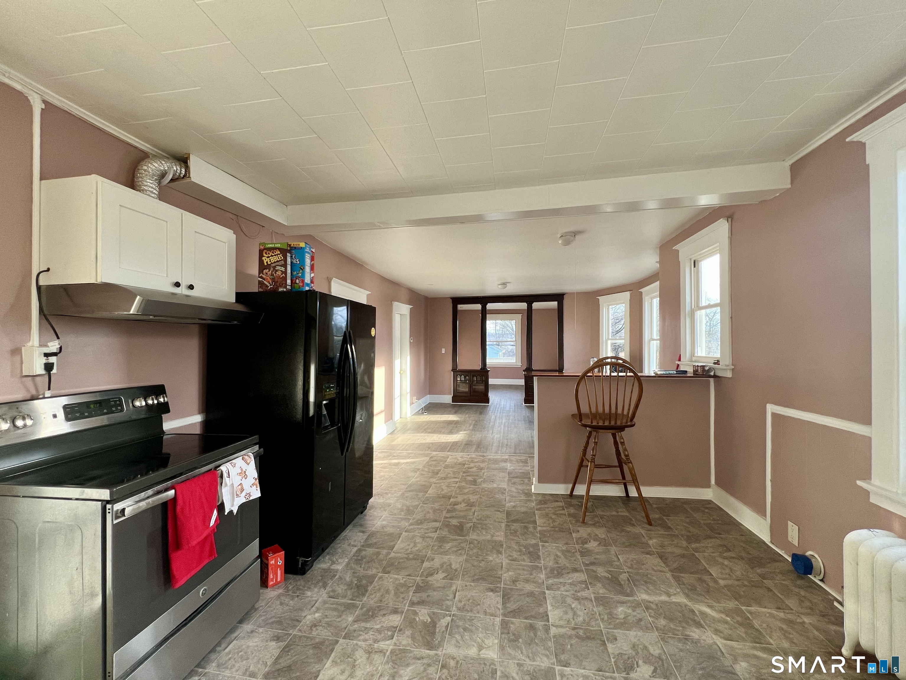154 High Street Torrington, CT 06790 - Photo 21 of 36 a kitchen with stainless steel appliances granite countertop a refrigerator and a stove top oven