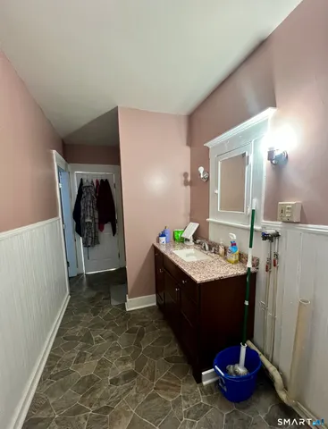 a spacious bathroom with a double vanity sink toilet and mirror