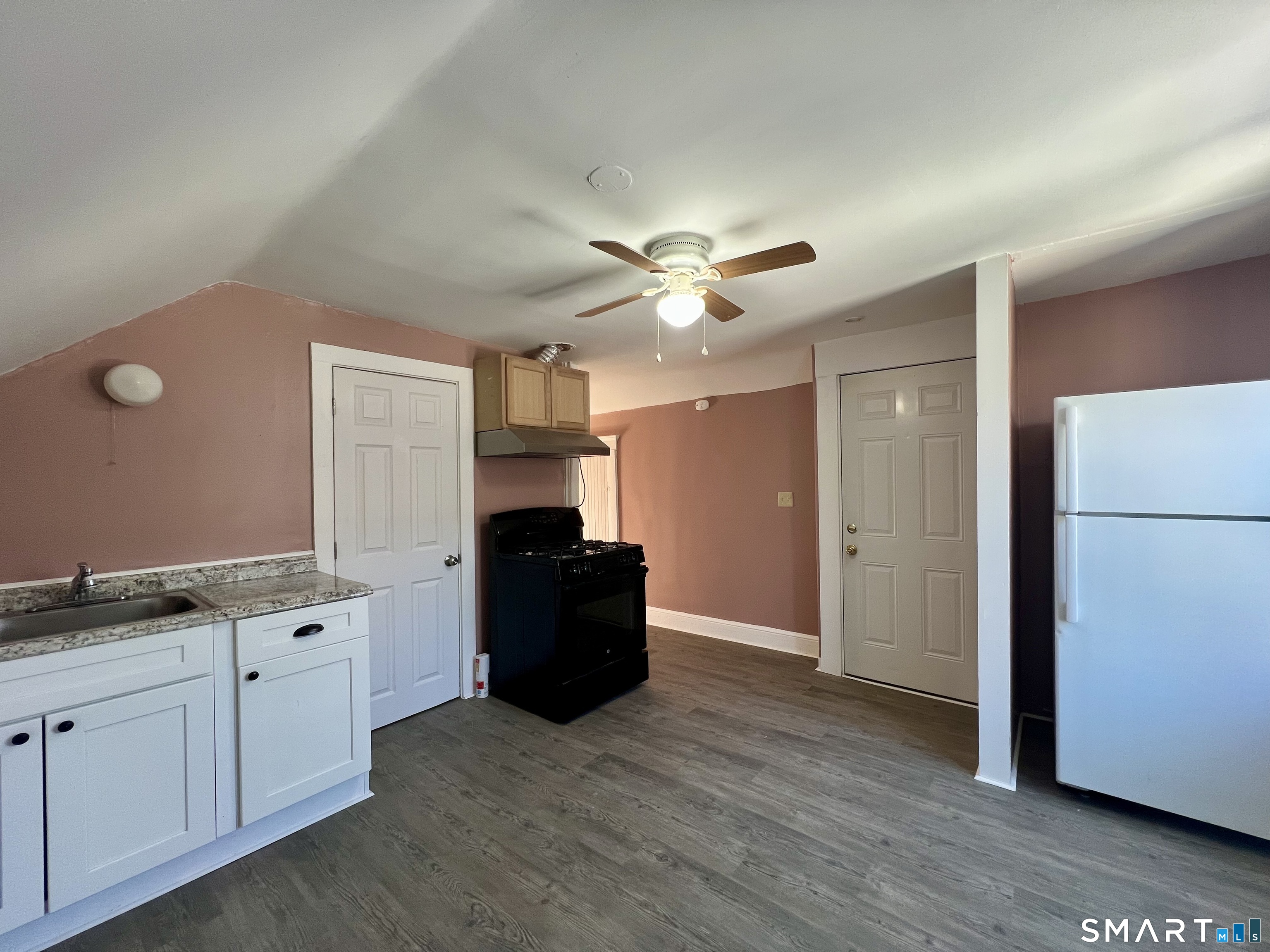 154 High Street Torrington, CT 06790 - Photo 29 of 36 a view of cabinets with wooden floor and windows