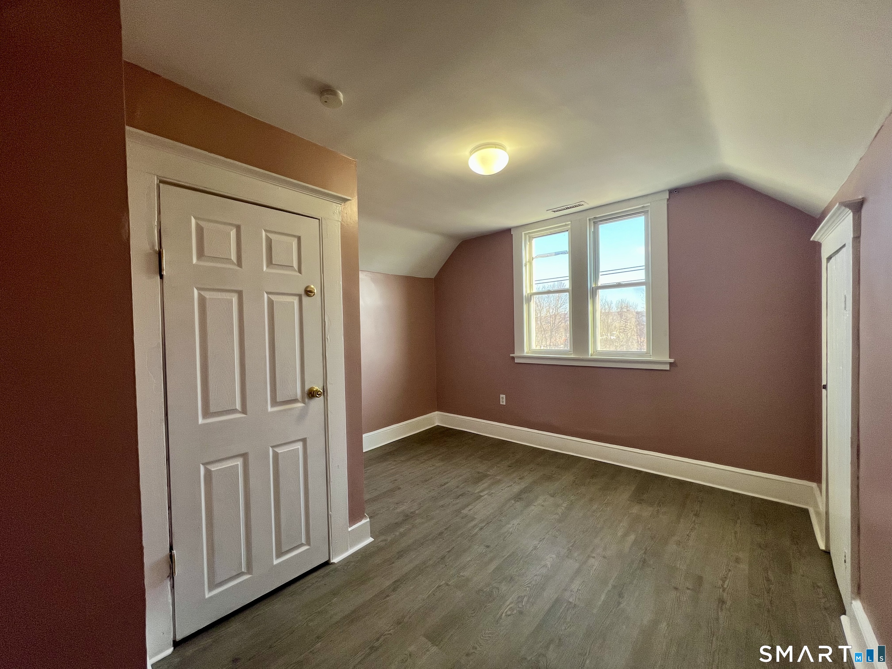 154 High Street Torrington, CT 06790 - Photo 35 of 36 an empty room with wooden floor closet and windows
