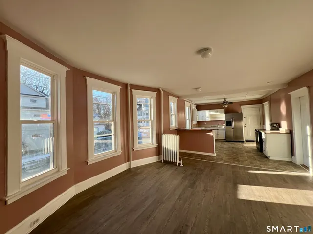a view of a kitchen with fridge and windows