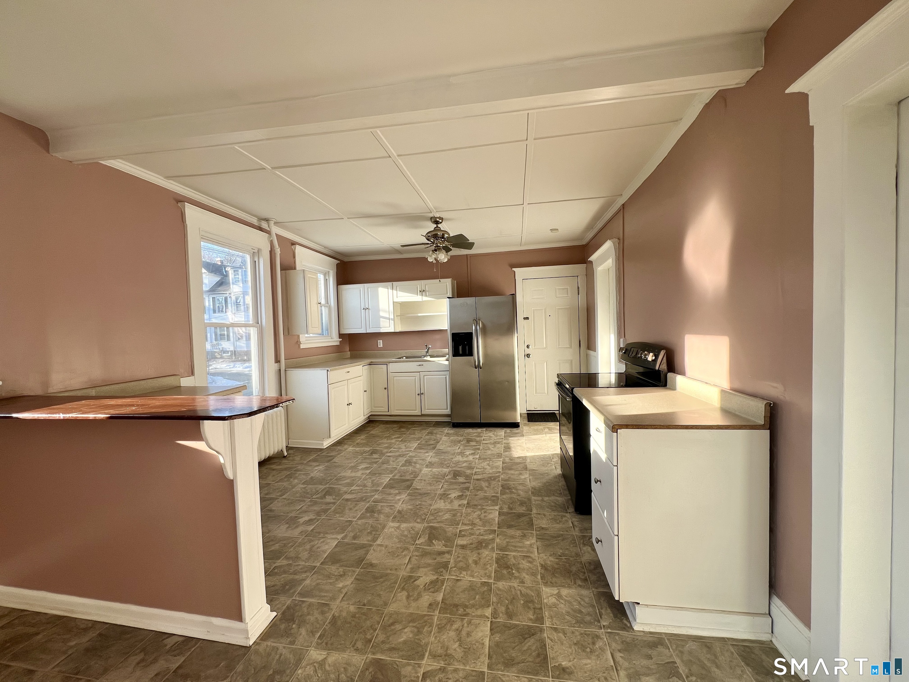 154 High Street Torrington, CT 06790 - Photo 10 of 36 a view of a kitchen with fridge and windows