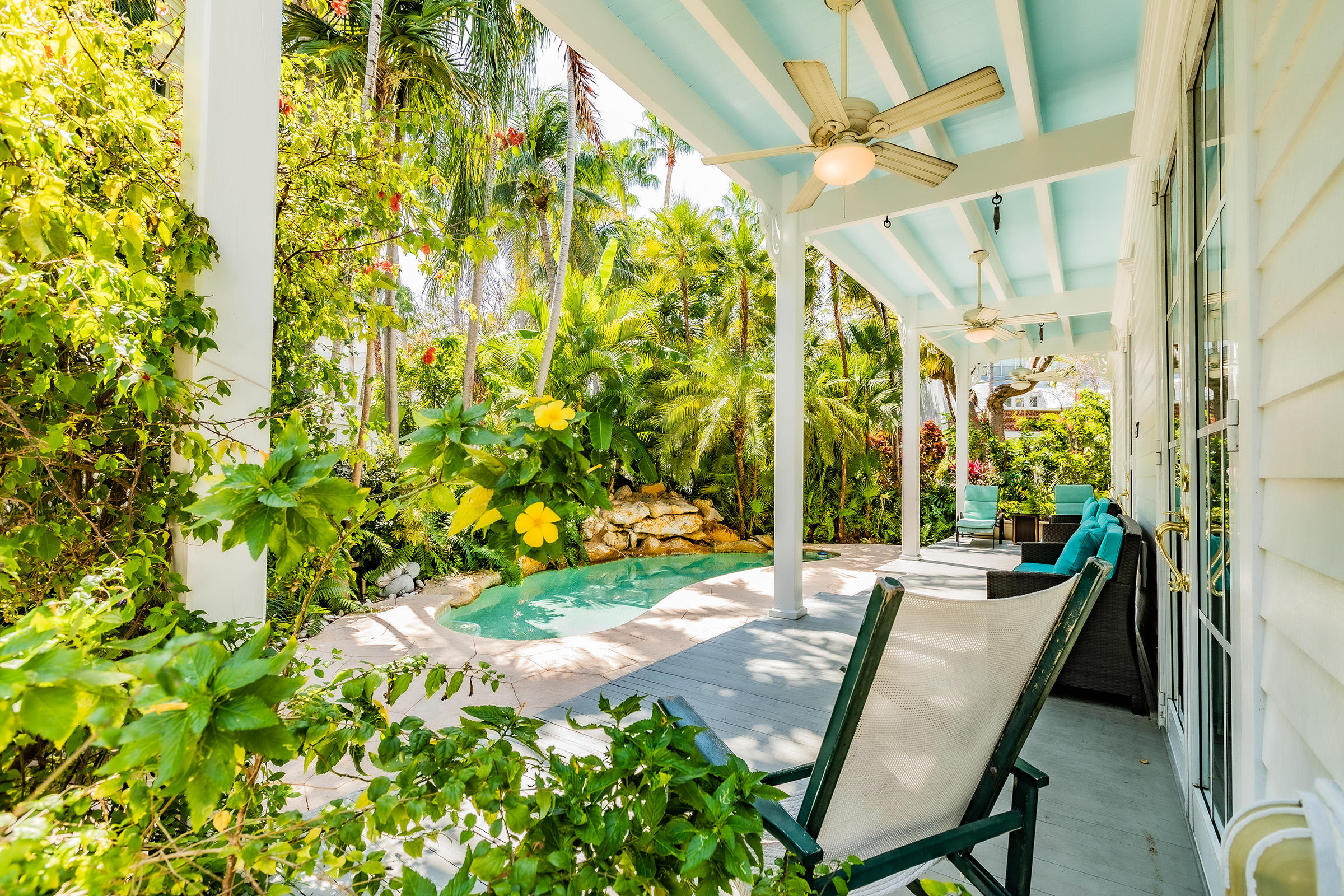 66 Front Street Key West, FL 33040 - Photo 4 of 8 a view of a patio with table and chairs and potted plants