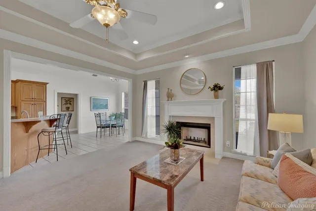 a living room with furniture a fireplace and a table