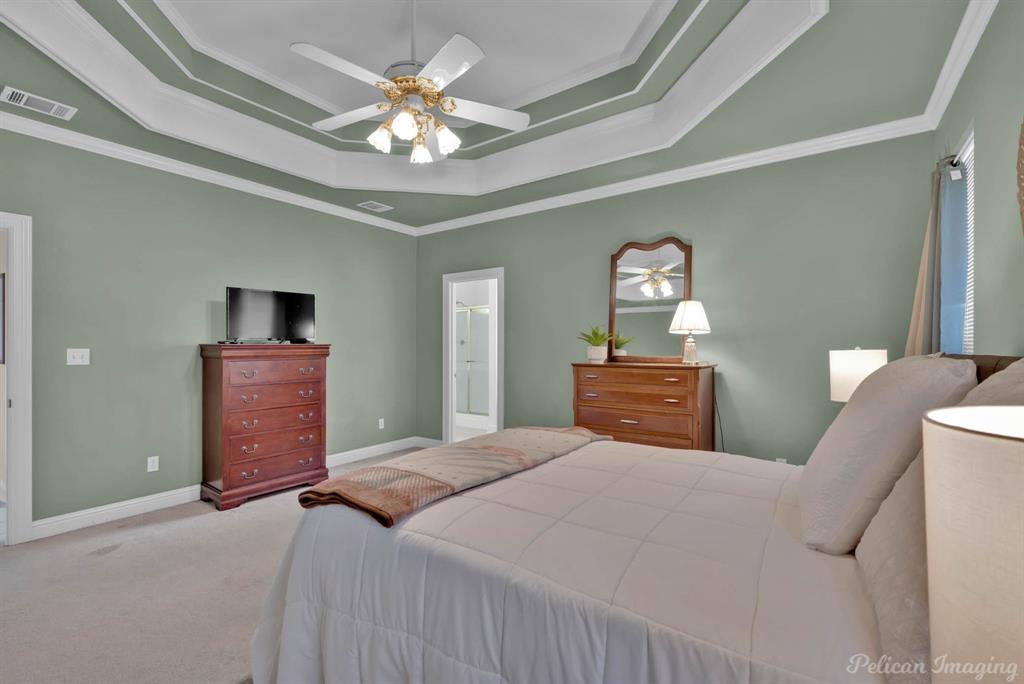 1413 Magnolia Ridge Bossier City, LA 71112 - Photo 15 of 29 a bedroom with a bed and a chandelier