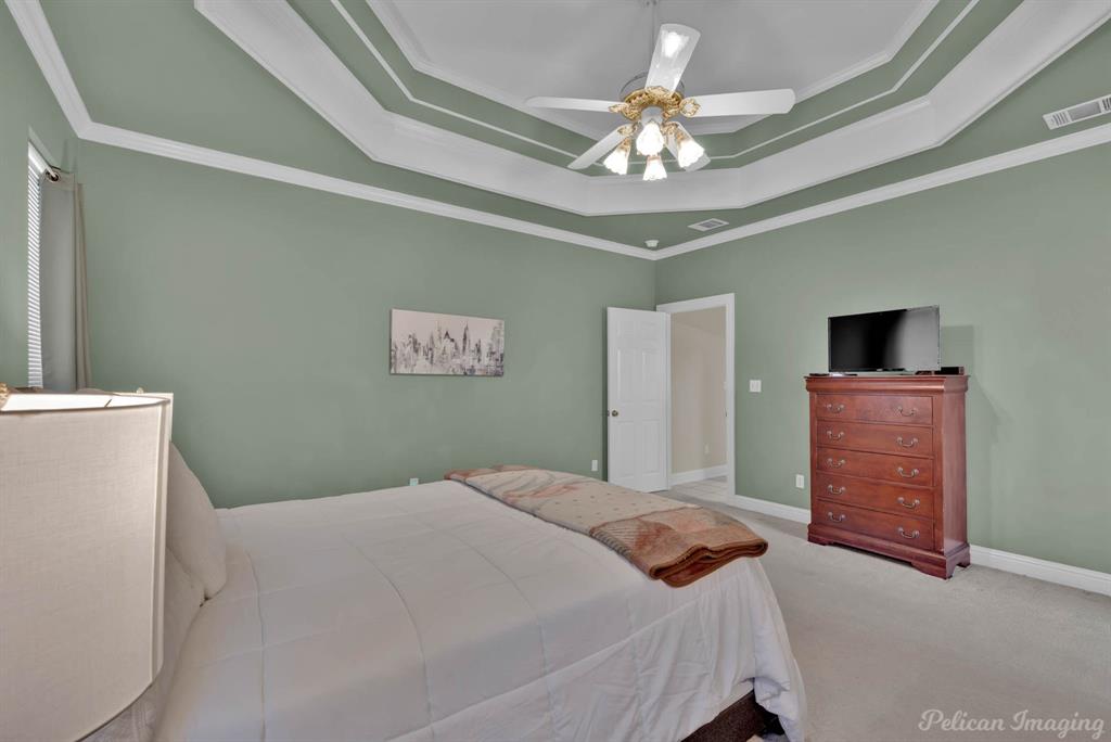 1413 Magnolia Ridge Bossier City, LA 71112 - Photo 16 of 29 a bedroom with a bed and a chandelier