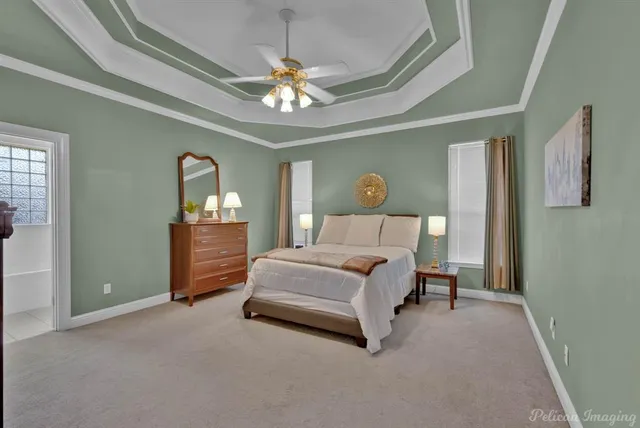 a spacious bedroom with a bed and a chandelier