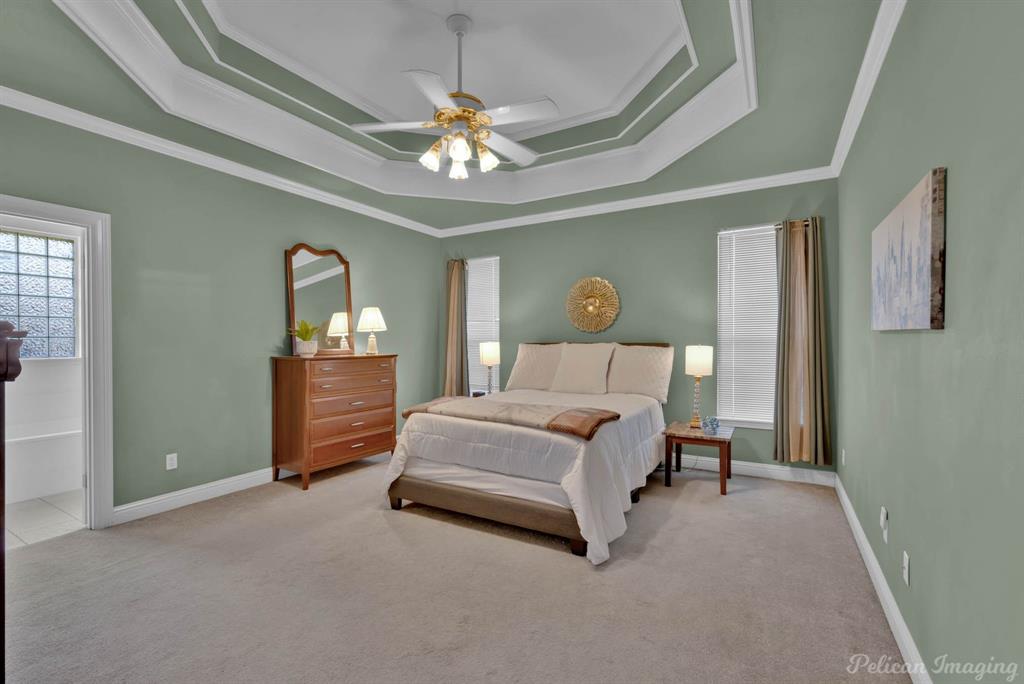 1413 Magnolia Ridge Bossier City, LA 71112 - Photo 17 of 29 a spacious bedroom with a bed and a chandelier