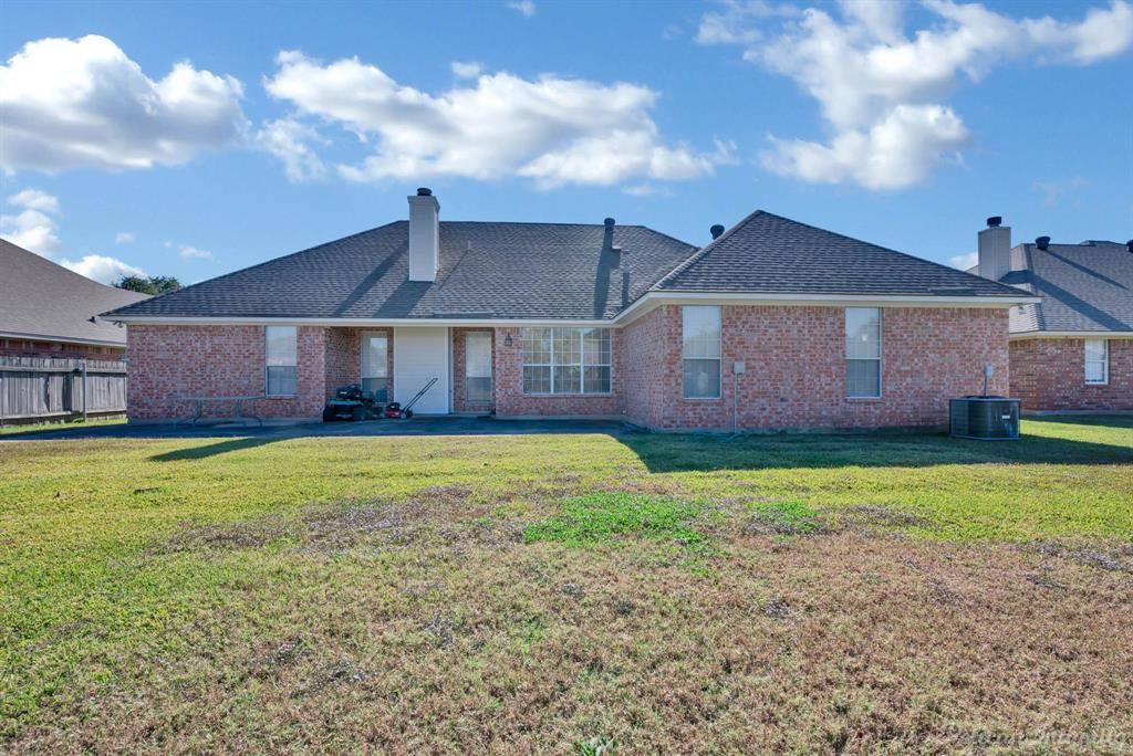 1413 Magnolia Ridge Bossier City, LA 71112 - Photo 18 of 29 a front view of a house with a garden and yard