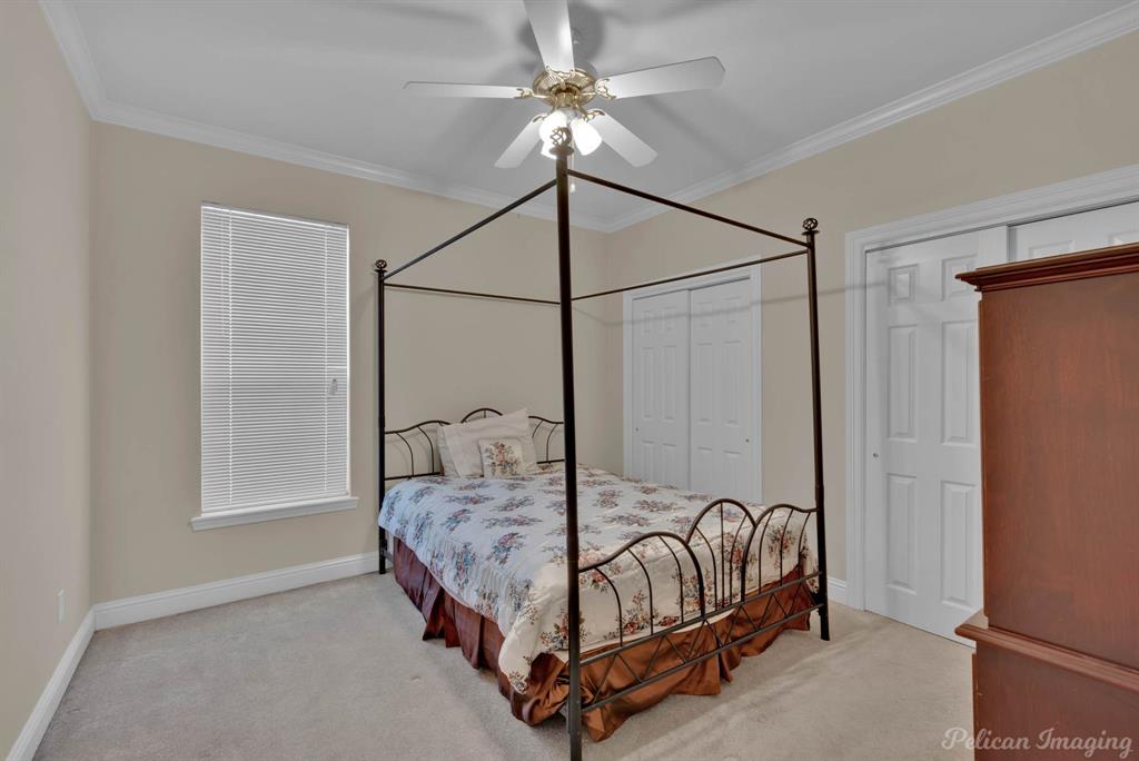 1413 Magnolia Ridge Bossier City, LA 71112 - Photo 28 of 29 a bedroom with a bed and a chandelier