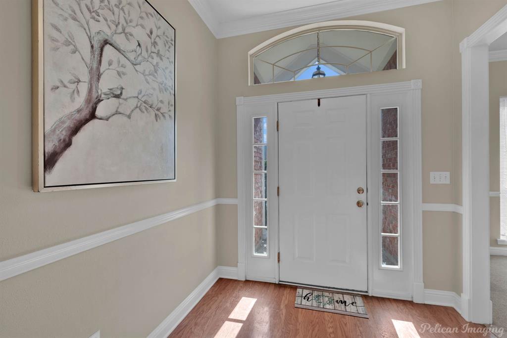 1413 Magnolia Ridge Bossier City, LA 71112 - Photo 4 of 29 a view of a hallway with entryway wooden floor and front door