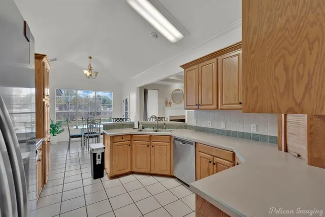 a kitchen with a sink cabinets and window