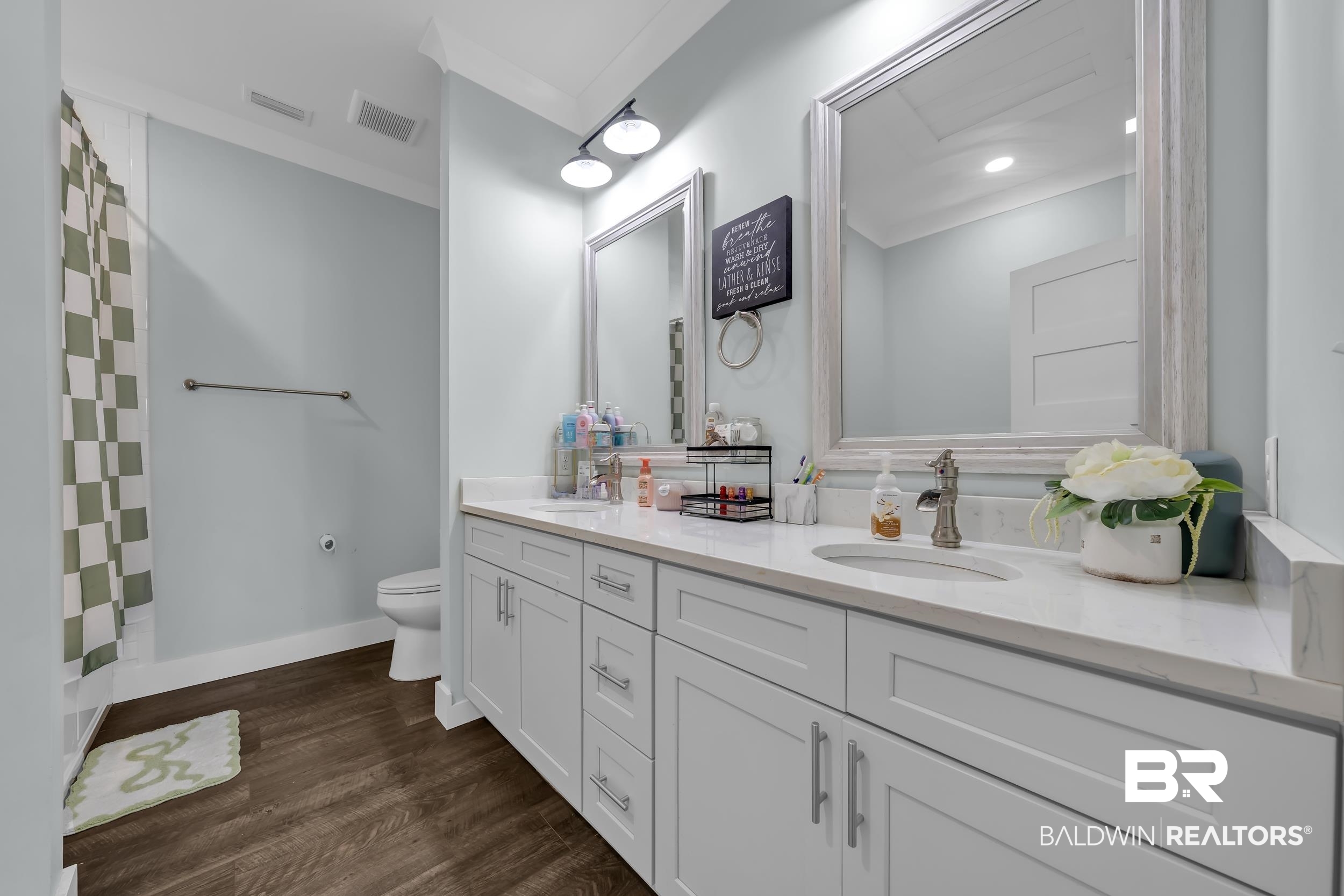 6576 Ranch Loop Road East Grand Bay, AL 36541 - Photo 29 of 39 Bathroom with a double vanity featuring white shaker-style cabinetry, a light-toned countertop, and dual framed mirrors