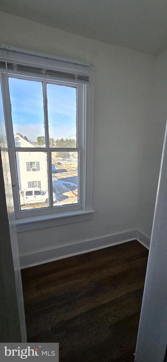 29 North Main Street, Unit B Smithsburg, MD 21783 - Photo 11 of 15 a view of empty room with wooden floor and a window