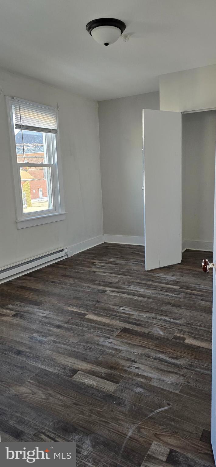29 North Main Street, Unit B Smithsburg, MD 21783 - Photo 7 of 15 an empty room with wooden floor and windows
