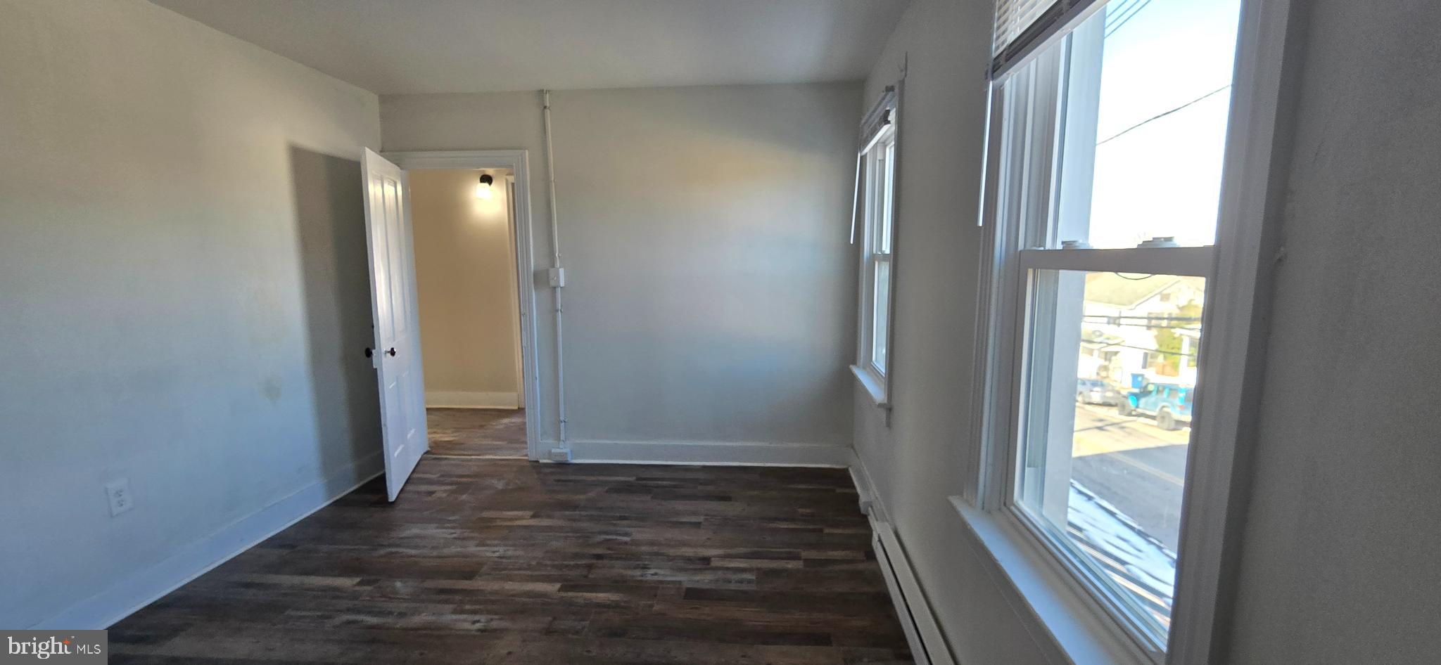 29 North Main Street, Unit B Smithsburg, MD 21783 - Photo 8 of 15 an empty room with wooden floor and windows