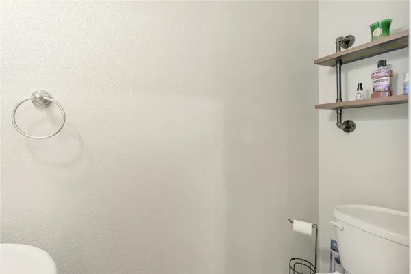 a white toilet sitting next to a bathroom sink