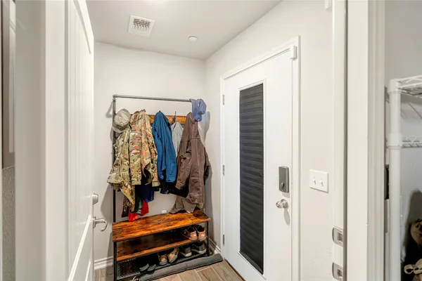 a view of walk in closet with clothes and shoes