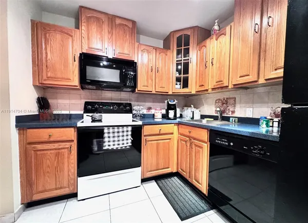 a kitchen with stainless steel appliances granite countertop a stove a sink dishwasher and a microwave