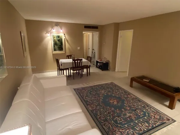 a living room with furniture rug and a table