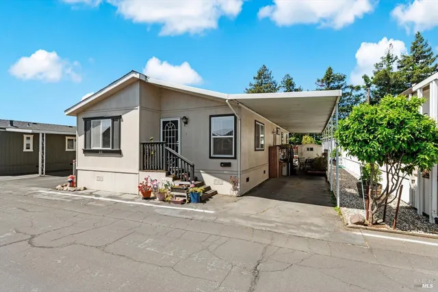 a view of a house with sitting area and potted plants