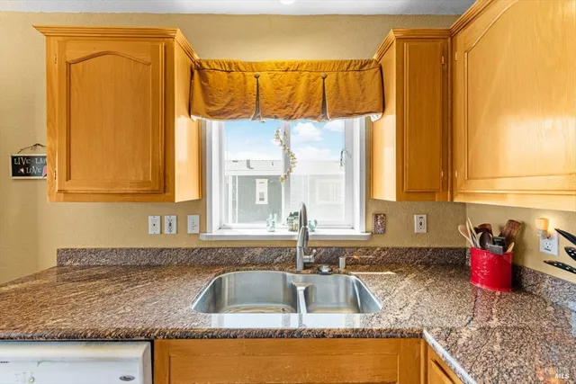 a kitchen with a sink a counter and a window