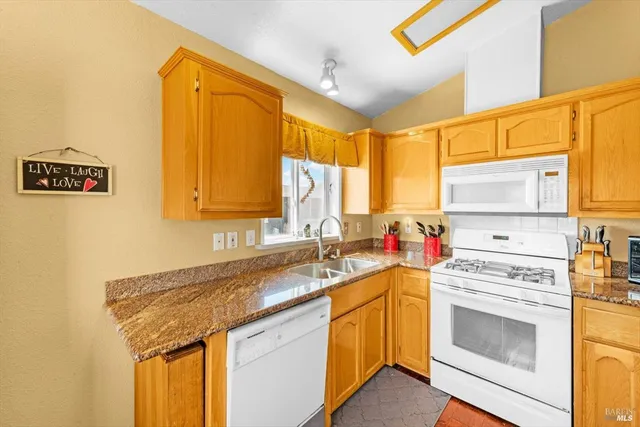 a kitchen that has a sink and a stove
