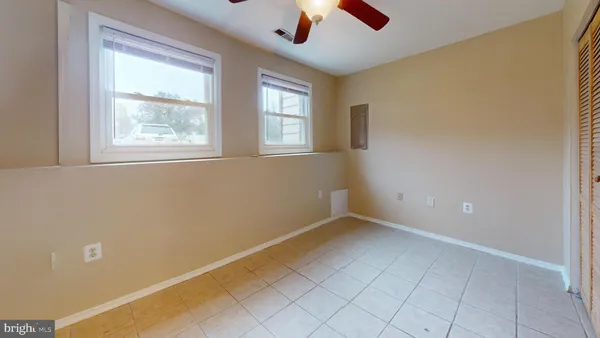a view of an empty room with window and cabinet