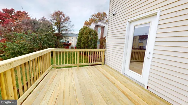 a view of balcony with wooden floor and fence