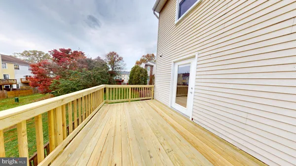 a view of a balcony with wooden floor and fence