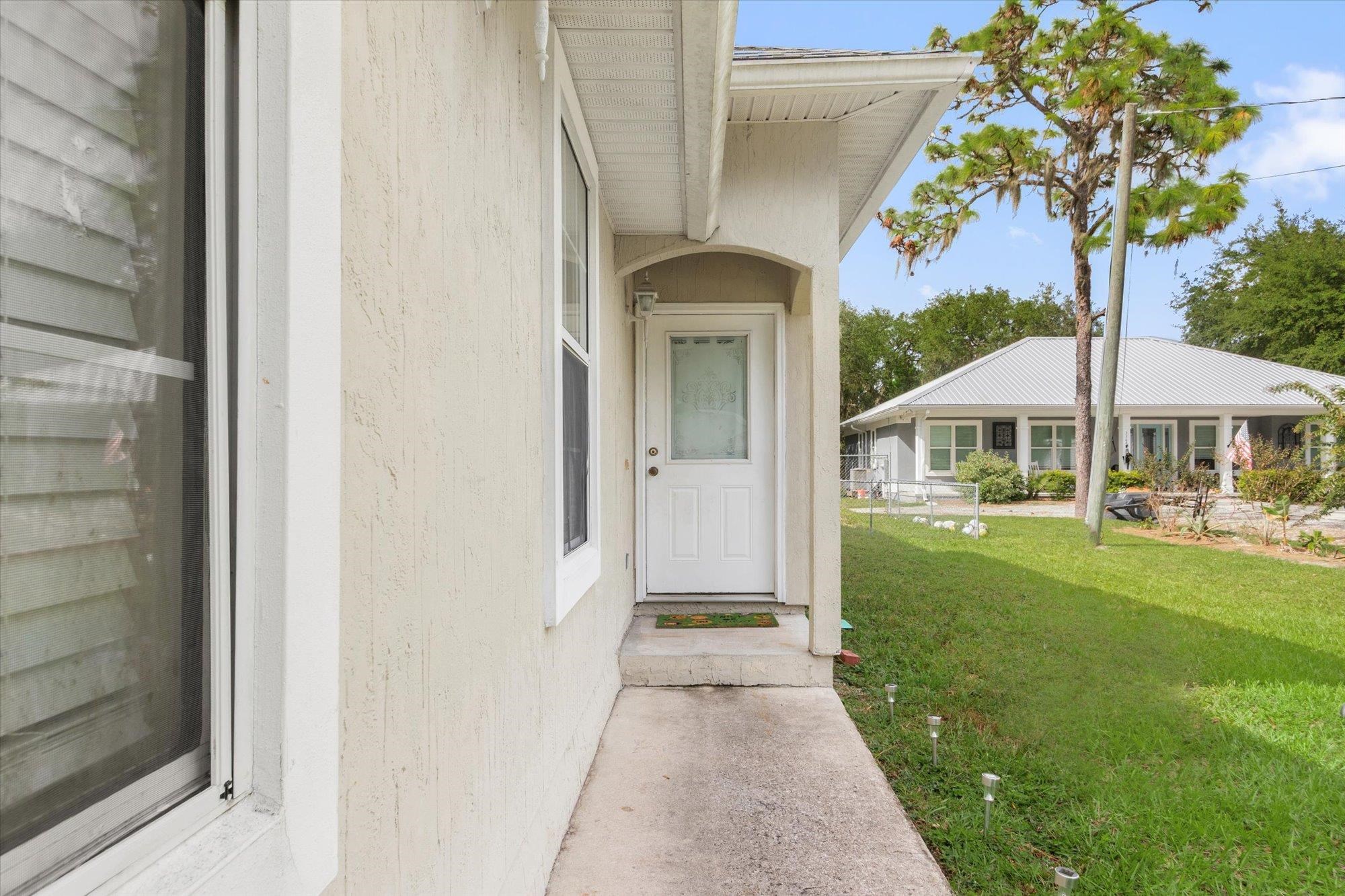 3372 4th Street Elkton, FL 32033 - Photo 27 of 36 a front view of a house with garden