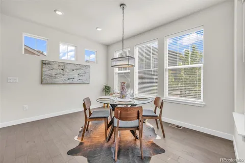 a dining room with furniture a chandelier and window
