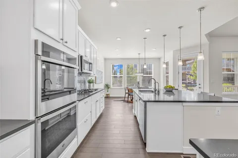 a kitchen with stainless steel appliances granite countertop a sink and stove top oven