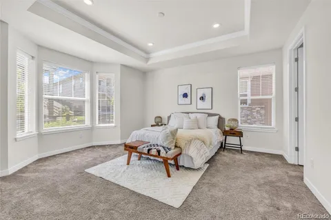 a spacious bedroom with a bed and a window