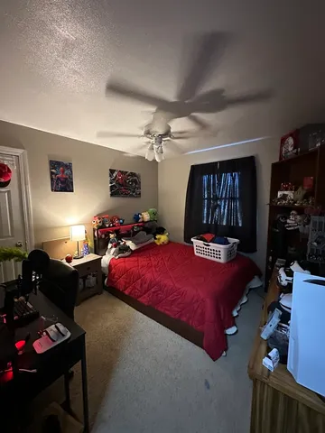 a bedroom with bed and a window